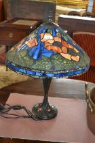 A reproduction Tiffany style table lamp with floral decorated shade, 62cm high