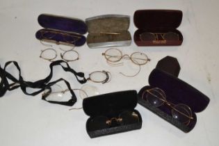 A bag containing a quantity of vintage spectacles and cases