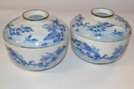 Two Oriental porcelain bowls and covers with blue and white designs, the covers with good luck