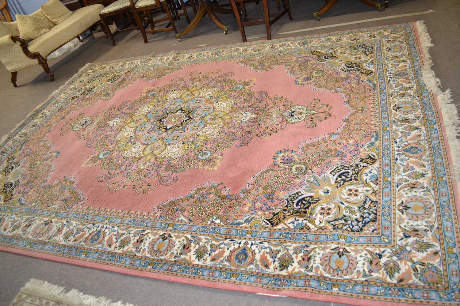 A 20th Century Turkish style wool rug decorated with a large central panel on a principally blue and - Image 2 of 2