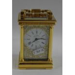 L'Eppe, a good quality brass cased carriage clock with white enamel dial with pierced metal fretwork