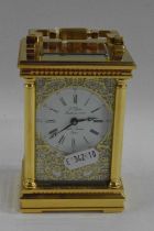 L'Eppe, a good quality brass cased carriage clock with white enamel dial with pierced metal fretwork