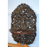 A Far Eastern hardwood wall bracket with extensive pierced foliate carved decoration, approx 50cm