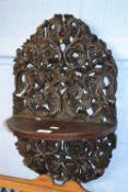 A Far Eastern hardwood wall bracket with extensive pierced foliate carved decoration, approx 50cm