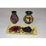 Group of three Moorcroft wares comprising two small baluster shape vases with the hibiscus design