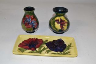 Group of three Moorcroft wares comprising two small baluster shape vases with the hibiscus design