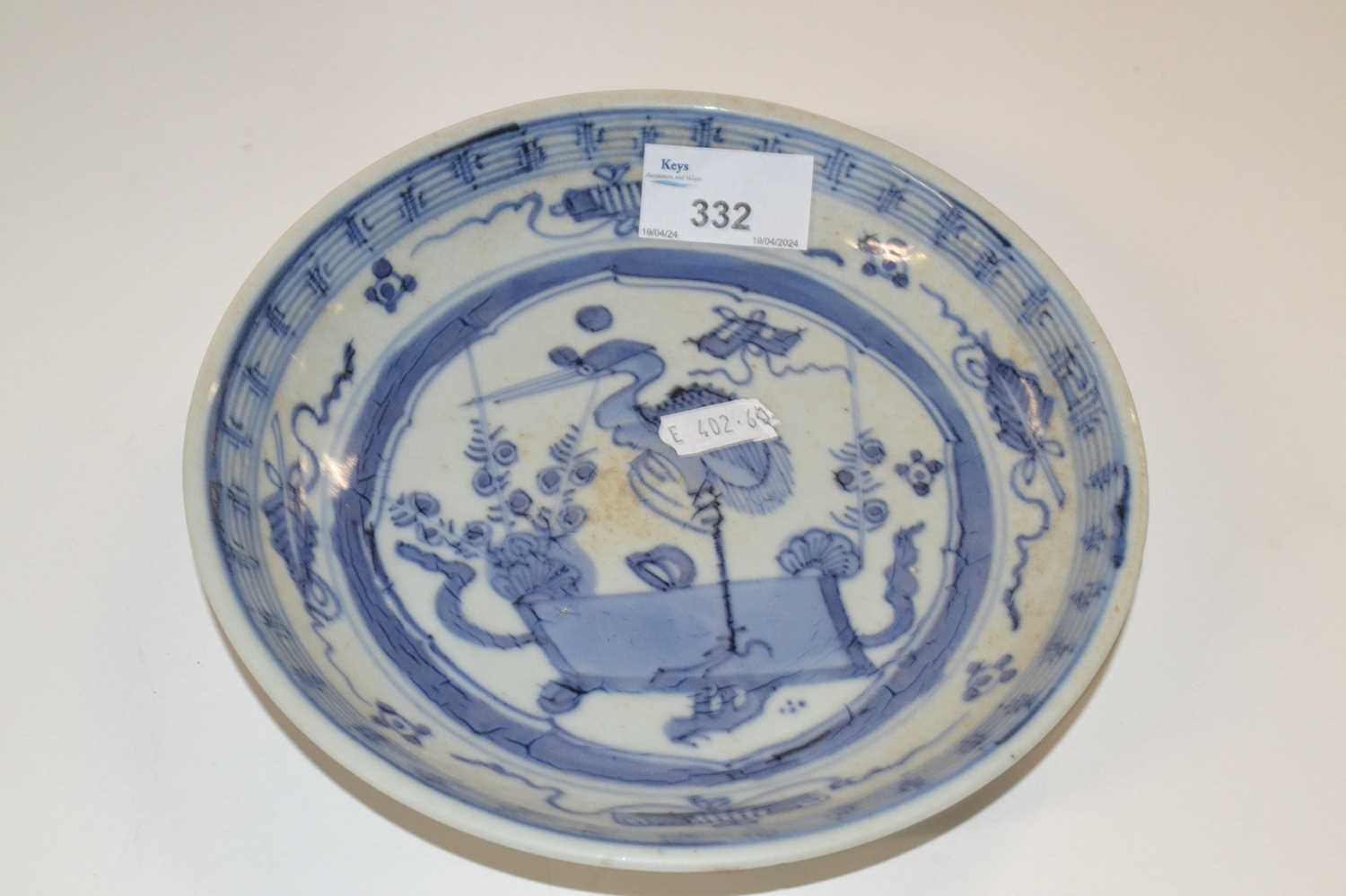 A Chinese porcelain bowl, the centre designed in blue with a stork surrounded by Buddhist symbols,