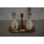 A Beswick pair of vinegar bottles on wooden stand by Beswick with floral decoration