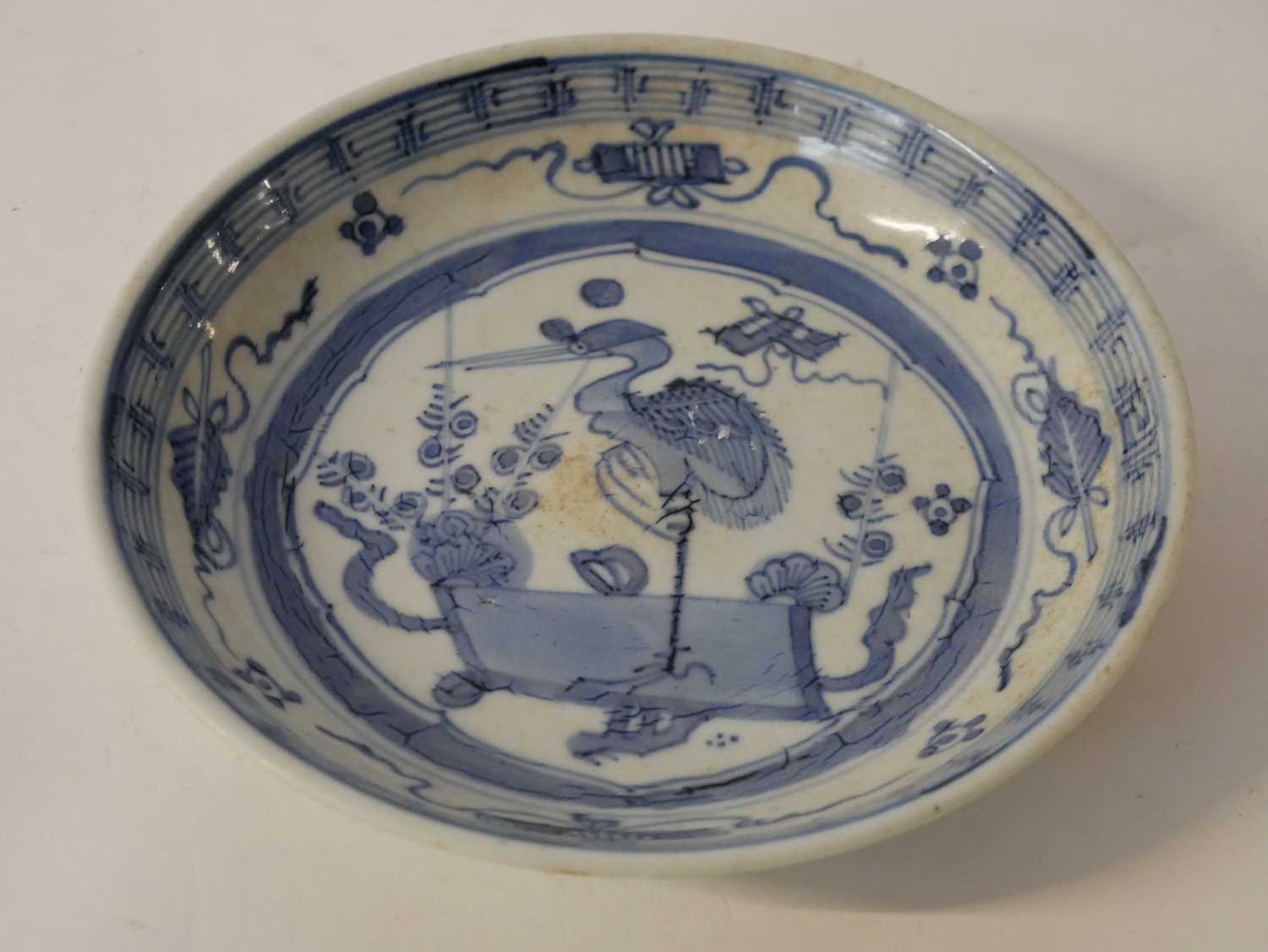 A Chinese porcelain bowl, the centre designed in blue with a stork surrounded by Buddhist symbols, - Image 3 of 4