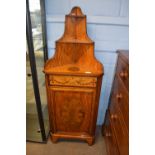 An unusual 19th Century satinwood corner cabinet with two shelves over a panelled door, decorated