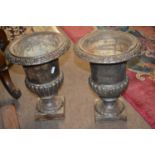 A pair of reproduction small cast iron garden urns, 30cm high