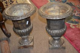 A pair of reproduction small cast iron garden urns, 30cm high