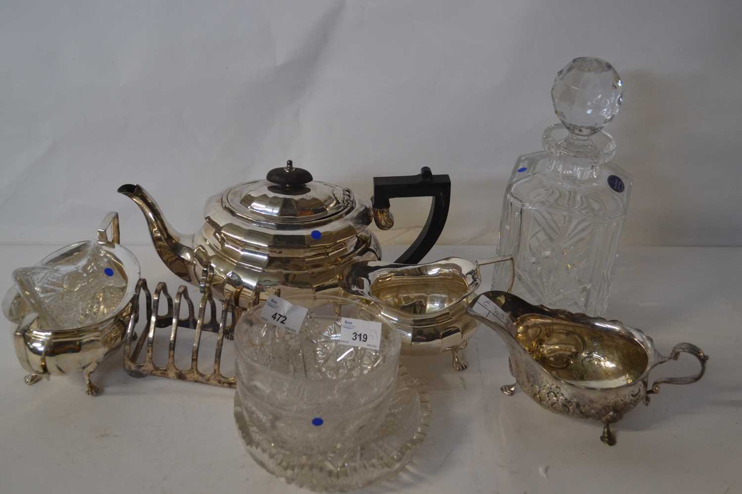 A silver plated tea set and toast rack together with a Royal Doulton crystal glass decanter and