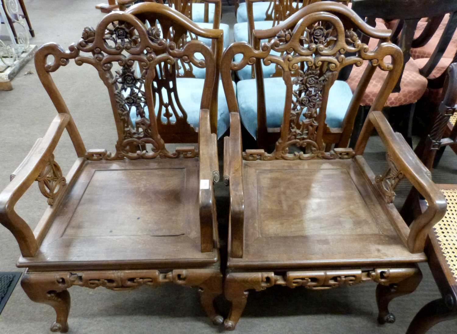 A pair of Chinese hardwood chairs with pierced floral decorated backs, 91cm