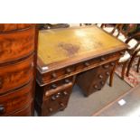 A late Victorian mahogany twin pedestal office desk with tooled leather top and turned knob handles,