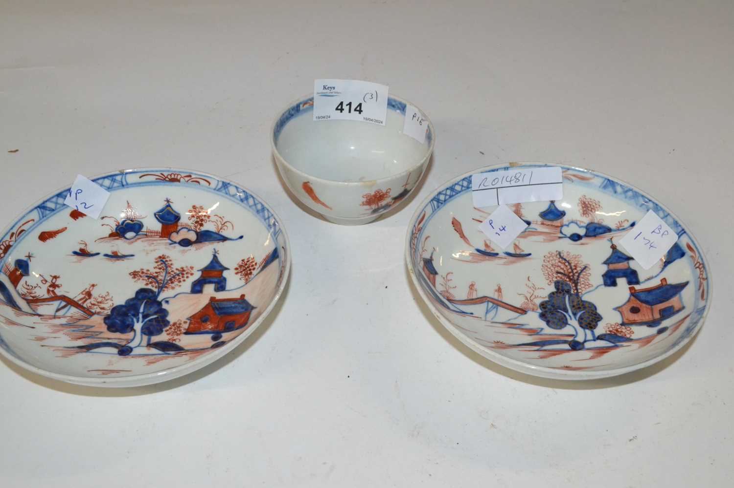 A Lowestoft porcelain tea bowl and saucer in the Dolls House pattern together with a further