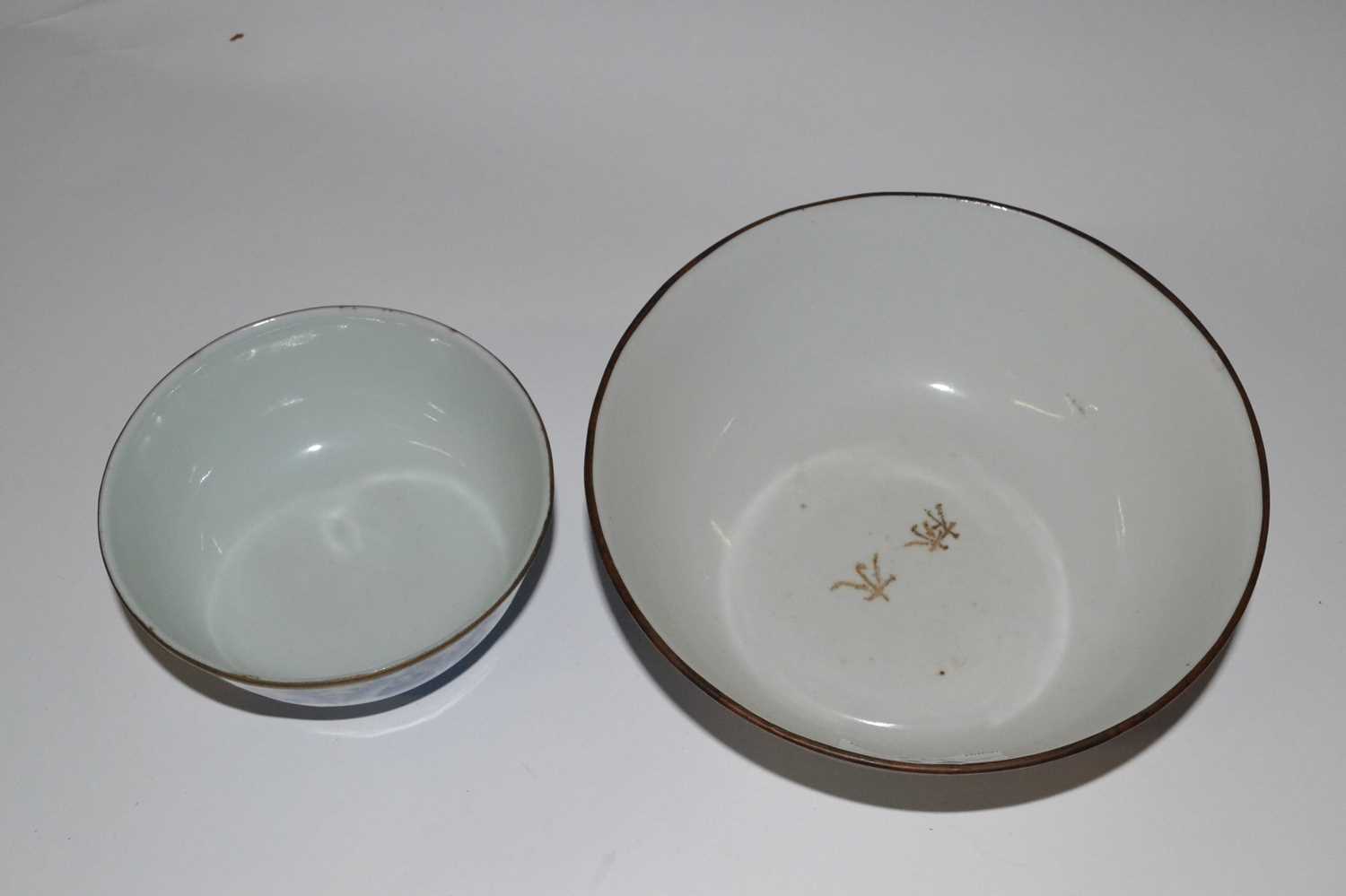 An Oriental porcelain bowl, possibly Japanese, with blue and white design and metal rim together - Image 2 of 3