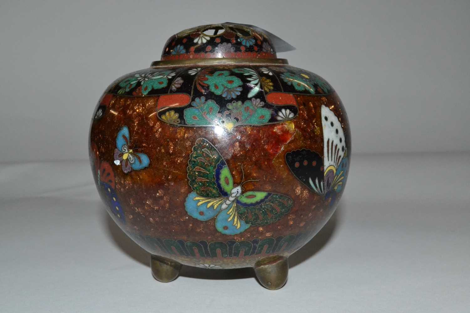 A Cloisonne bowl and cover, the bowl raise on three stub feet decorated with butterflies, the