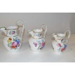 Three 19th Century Swansea style jugs decorated in relief with flower heads and painted floral