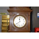 An early 20th Century oak cased grandmother clock with brass movement striking on steel rods,