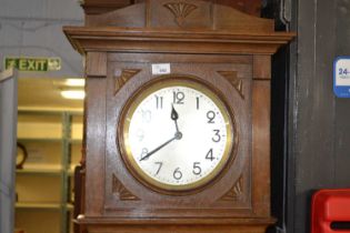 An early 20th Century oak cased grandmother clock with brass movement striking on steel rods,