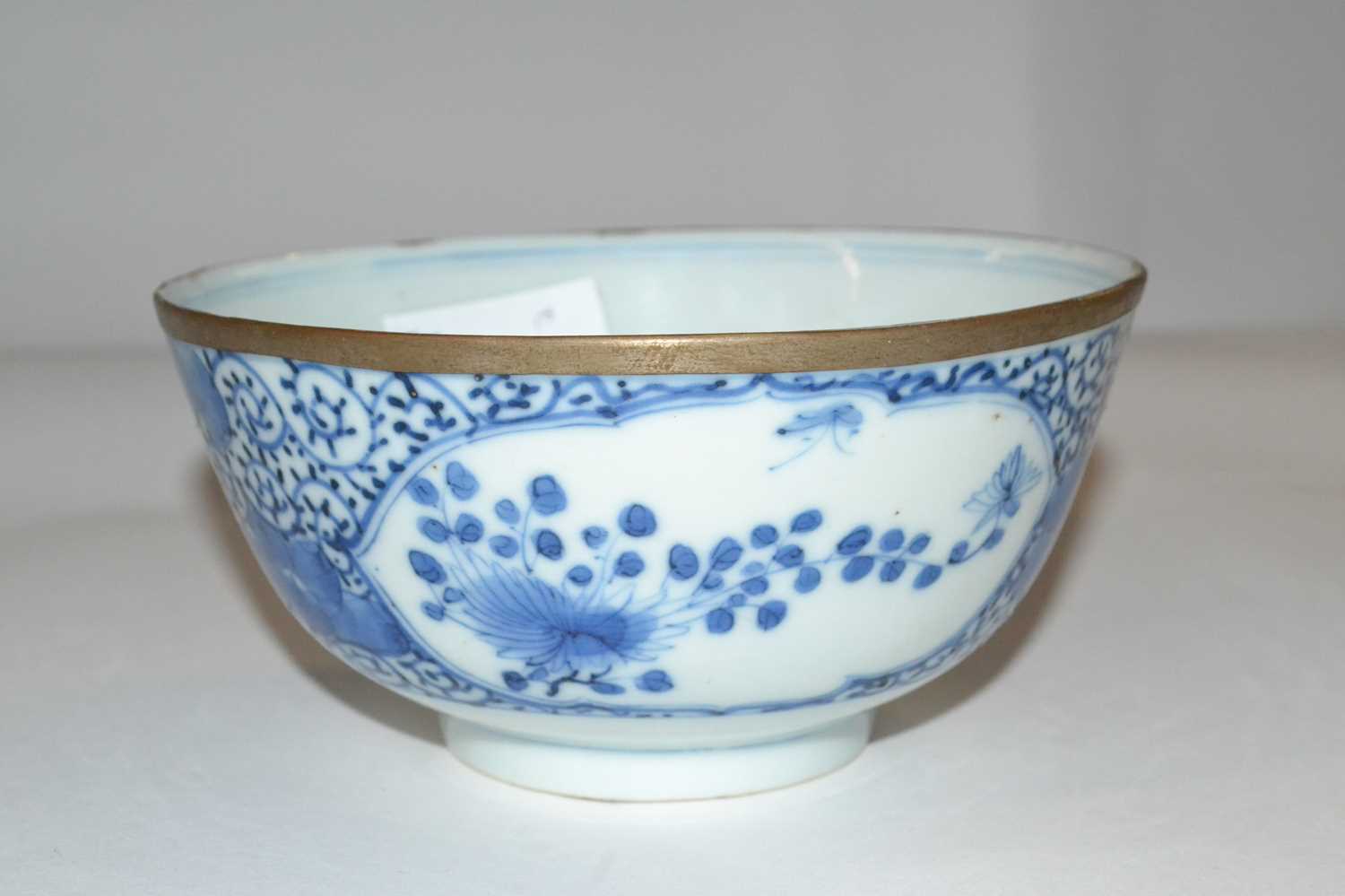 A Chinese porcelain bowl, 19th Century with blue and white floral design, four character mark to