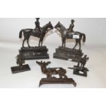 A pair of cast iron door stops formed as figures on horseback together with a further iron