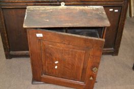 A George III oak wall cabinet with single panelled door and shelved interior, 56cm high