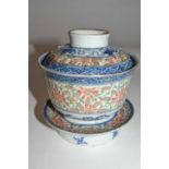 A Chinese porcelain rice bowl, cover and stand with rice grain polychrome design, the base with