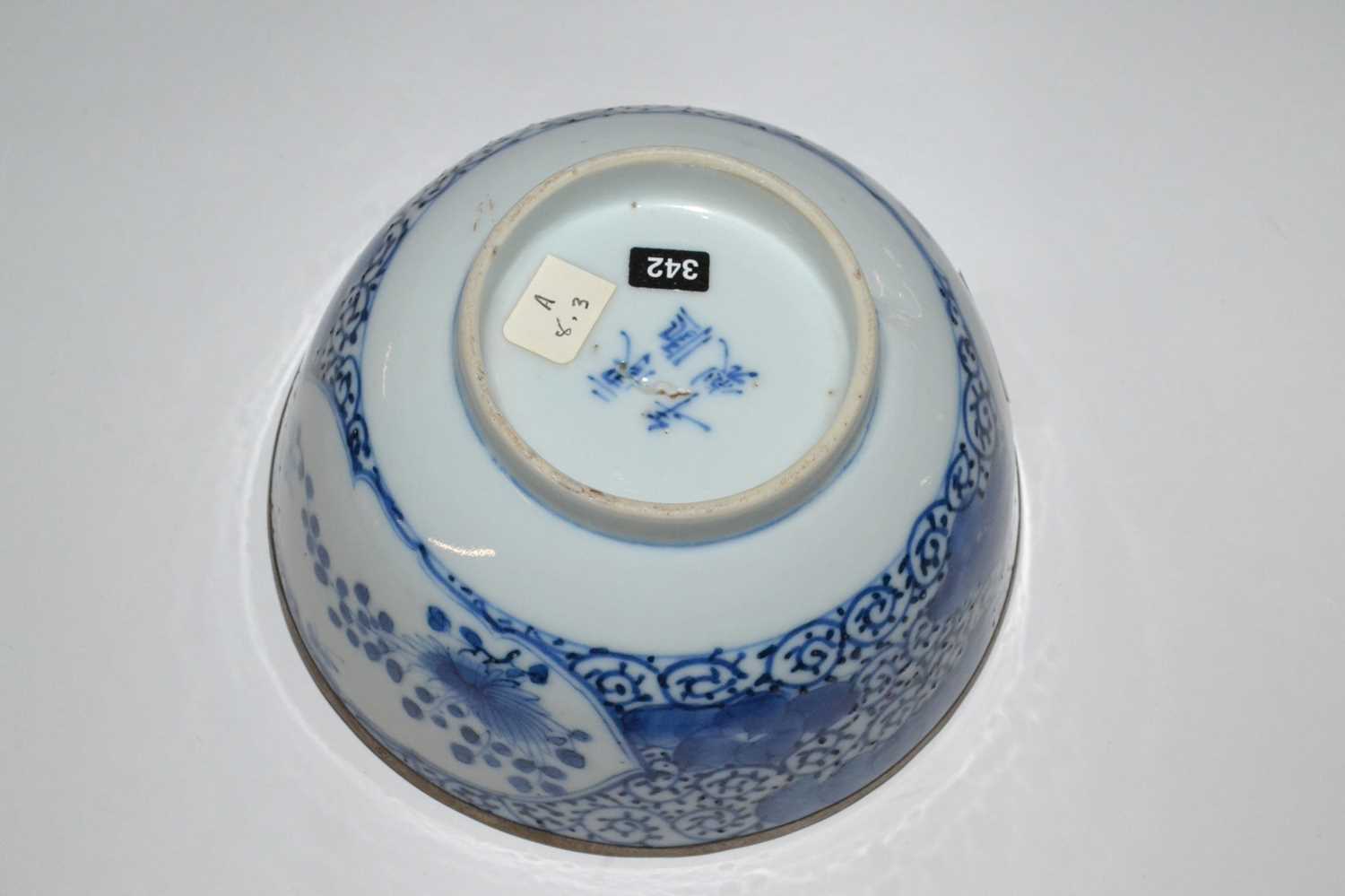 A Chinese porcelain bowl, 19th Century with blue and white floral design, four character mark to - Image 2 of 4