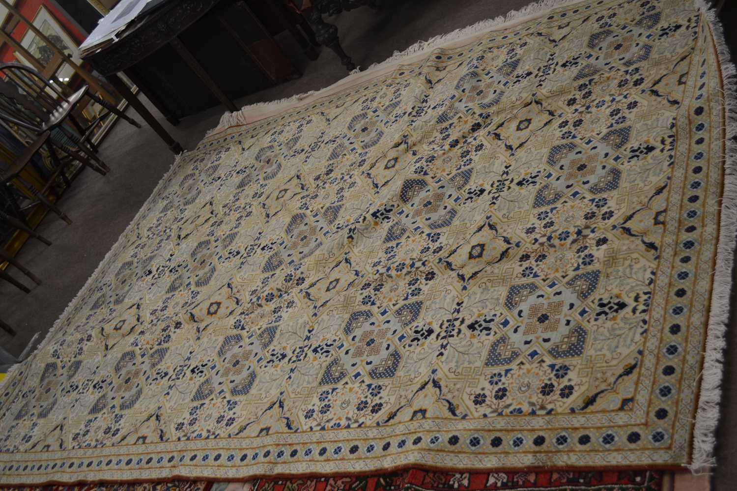 A modern Iranian Kashan rug, decorated with a stylised beige and blue geometric design, 310 x 210cm