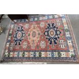 20th Century Afghan wool rug decorated with a large central panel with geometric lozenges surrounded