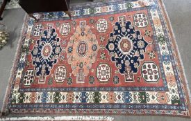 20th Century Afghan wool rug decorated with a large central panel with geometric lozenges surrounded