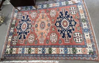 20th Century Afghan wool rug decorated with a large central panel with geometric lozenges surrounded