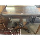 An early 19th Century rosewood card table, the top with red baize lining set on a fluted column with