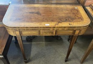 A Georgian mahogany and inlaid card table with D shaped top raised on tapering legs with spade feet,