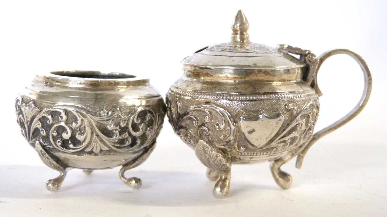 Antique 19th Century Indian silver condiment set featuring mustard pot and salt decorated in cutch