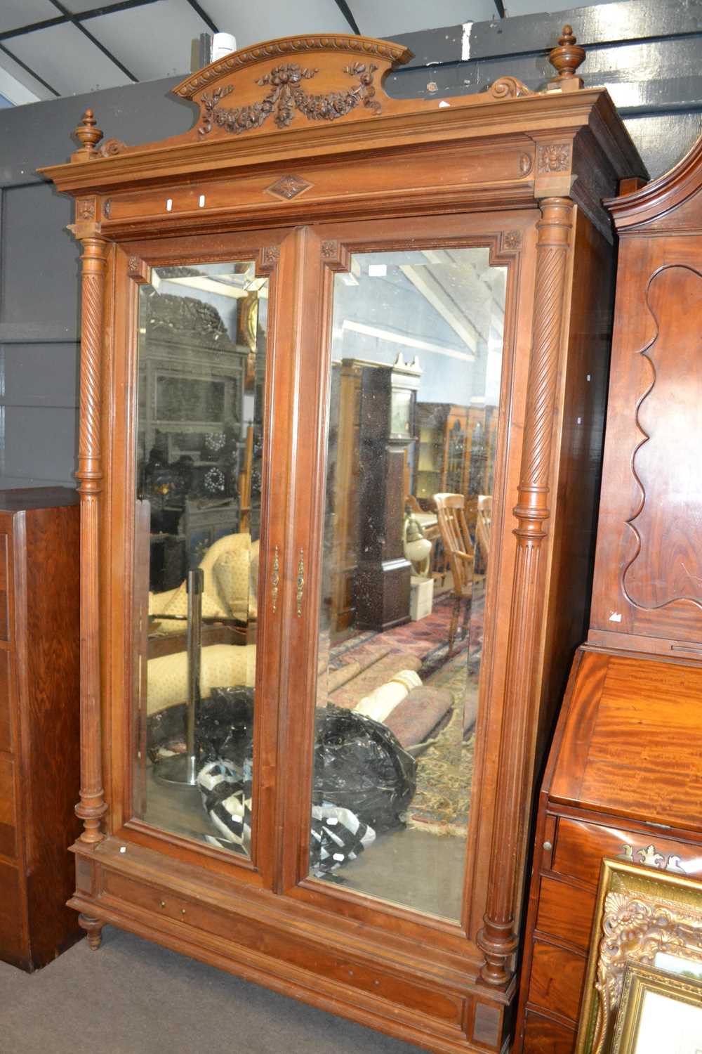 Late 19th Century continental walnut wardrobe or cupboard with arched pediment, two doors with