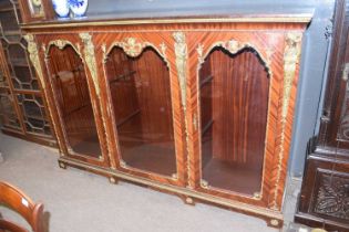 A large 20th Century mahogany veneered and metal mounted bookcase or display cabinet in the French