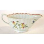 An 18th Century Bow porcelain sauce boat of ribbed form with floral decoration (hairline), 18cm