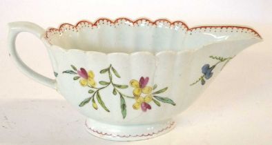 An 18th Century Bow porcelain sauce boat of ribbed form with floral decoration (hairline), 18cm