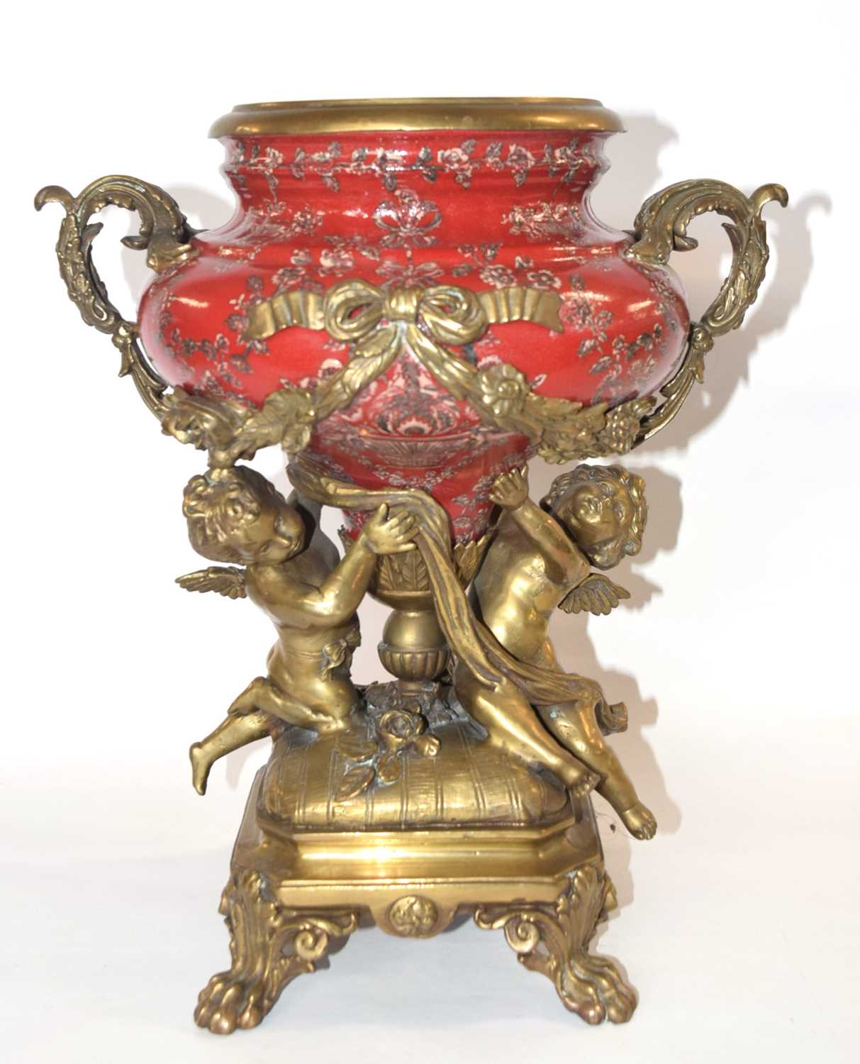 A large French Empire reproduction jardiniere, the ceramic body supported with two gilt metal
