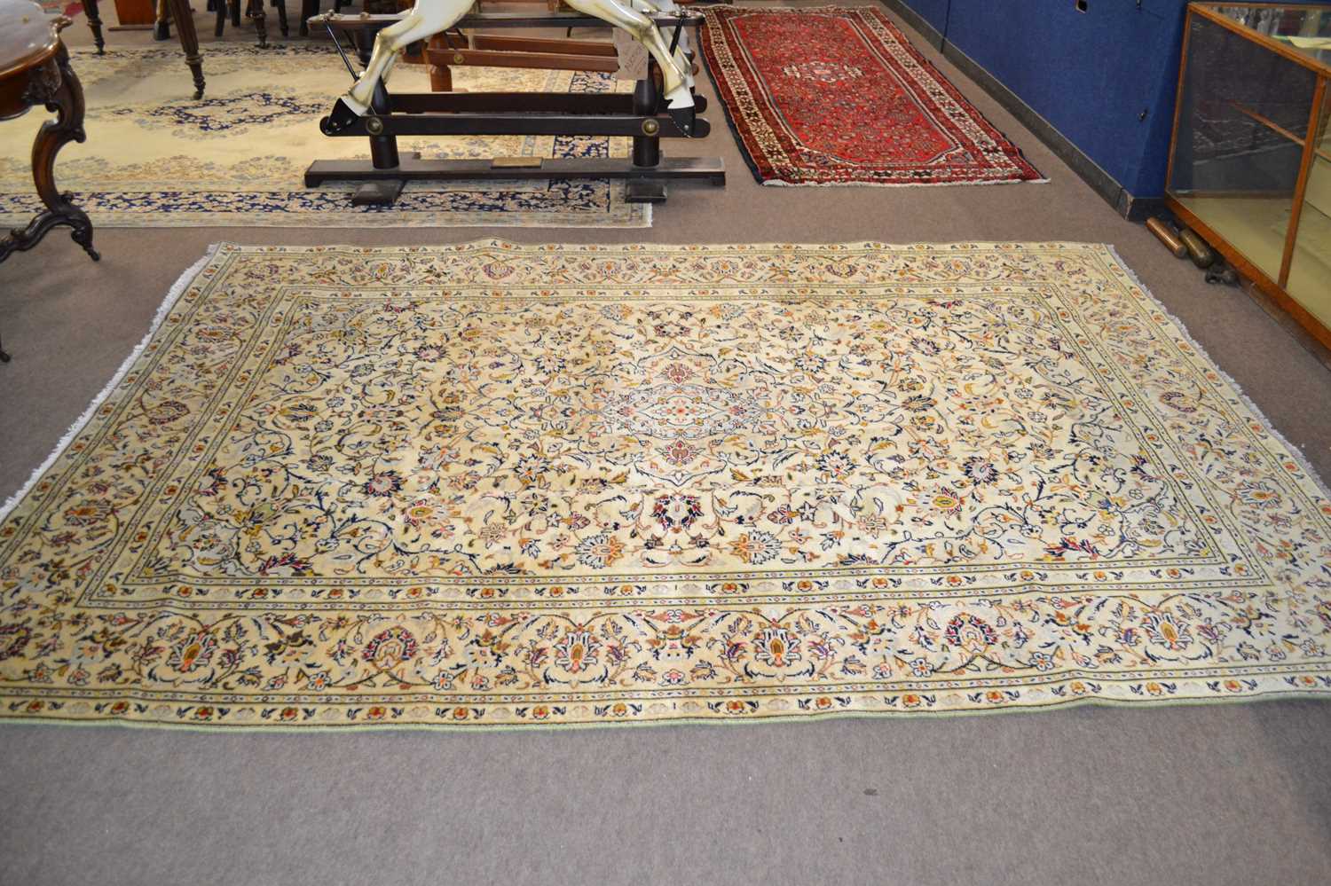 A modern Kashan carpet decorated with floral motifs on a pale background, 287 x 196cm