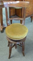 A Victorian revolving high back music chair on fluted legs