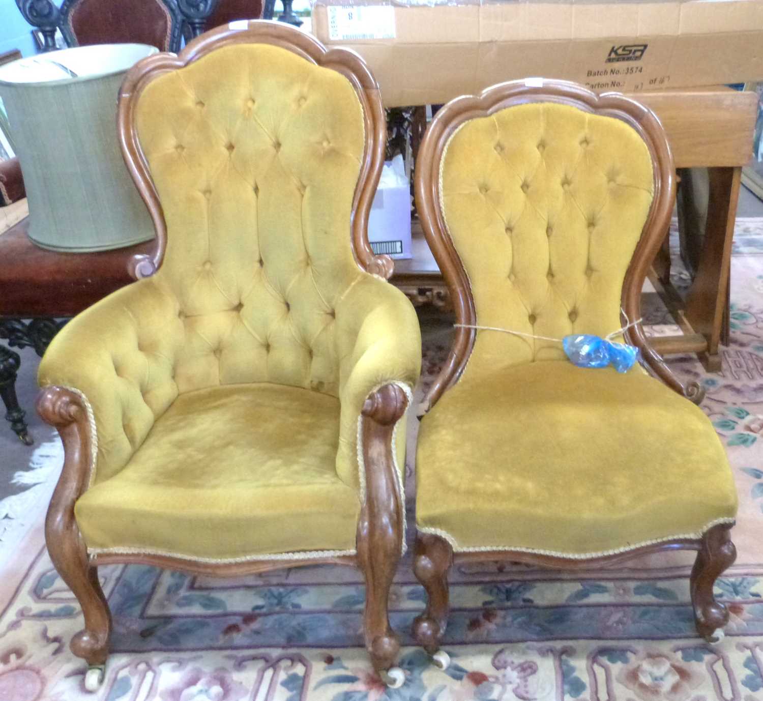 A pair of Victorian ladies and gents button upholstered chairs finished in mustard fabric with
