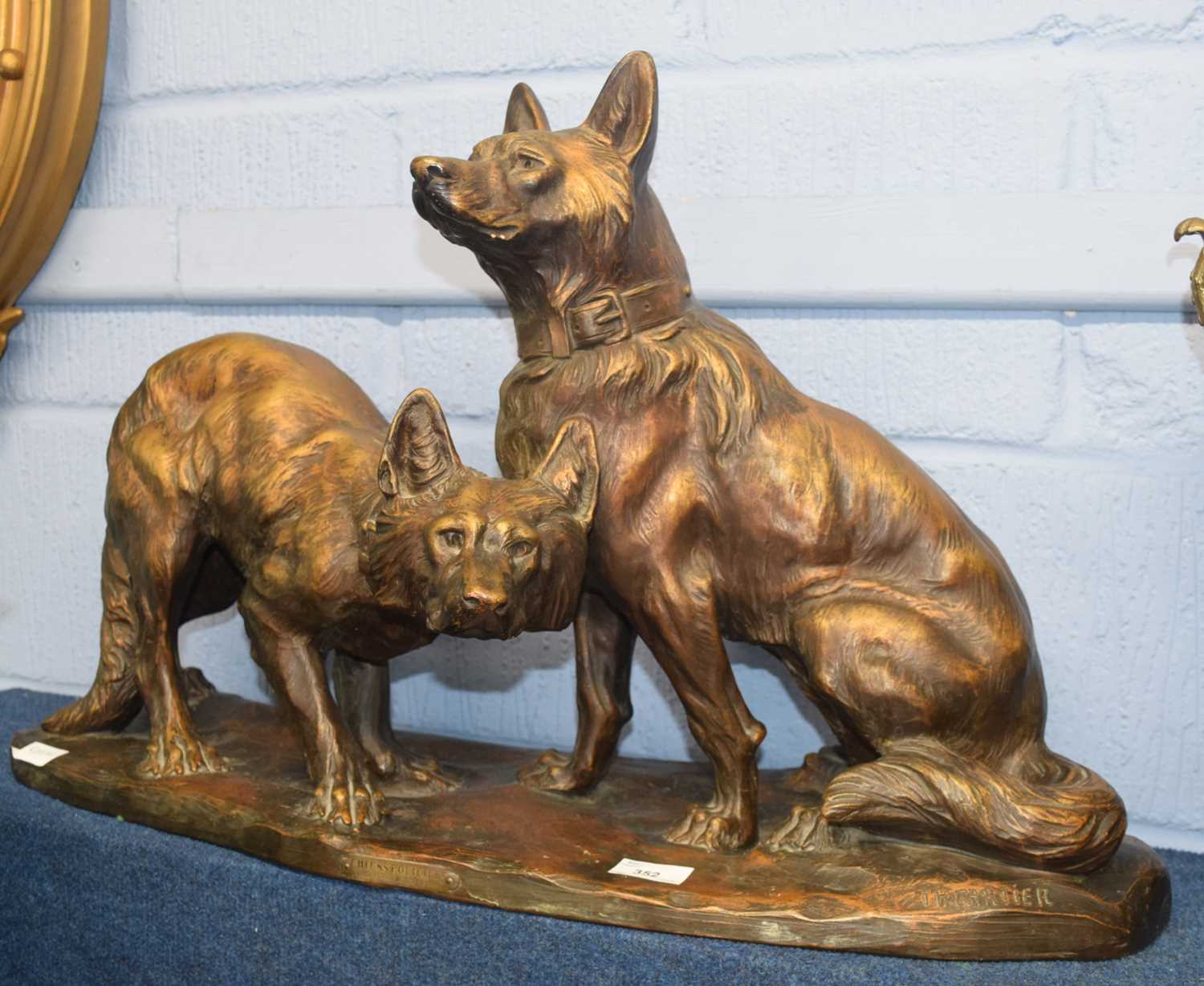 A large Spelter model of two dogs on simulated bronze base, the base impressed T H Cartier