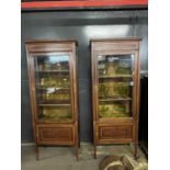 A pair of Edwardian mahogany and inlaid display cabinets with fabric lined interiors and cupboard