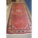 A Turkish wool runner carpet with large central medallion surroumded by a close geometric pattern on