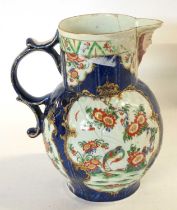 An 18th Century Worcester mask jug with blue ground with panels of Kakiemon style decoration (broken