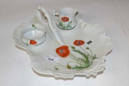 A Limoges porcelain dish with small bowl and jug, all painted with poppies (Inventory 306)